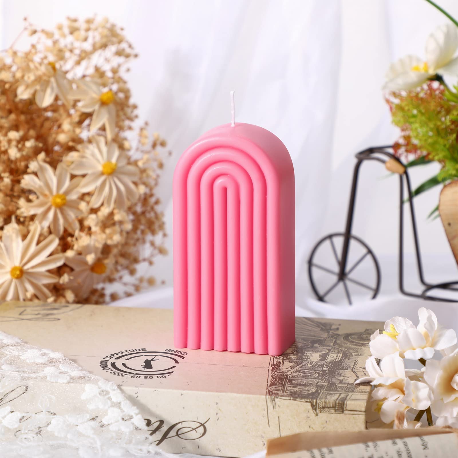 Coume pink arch candle in a bedroom setting