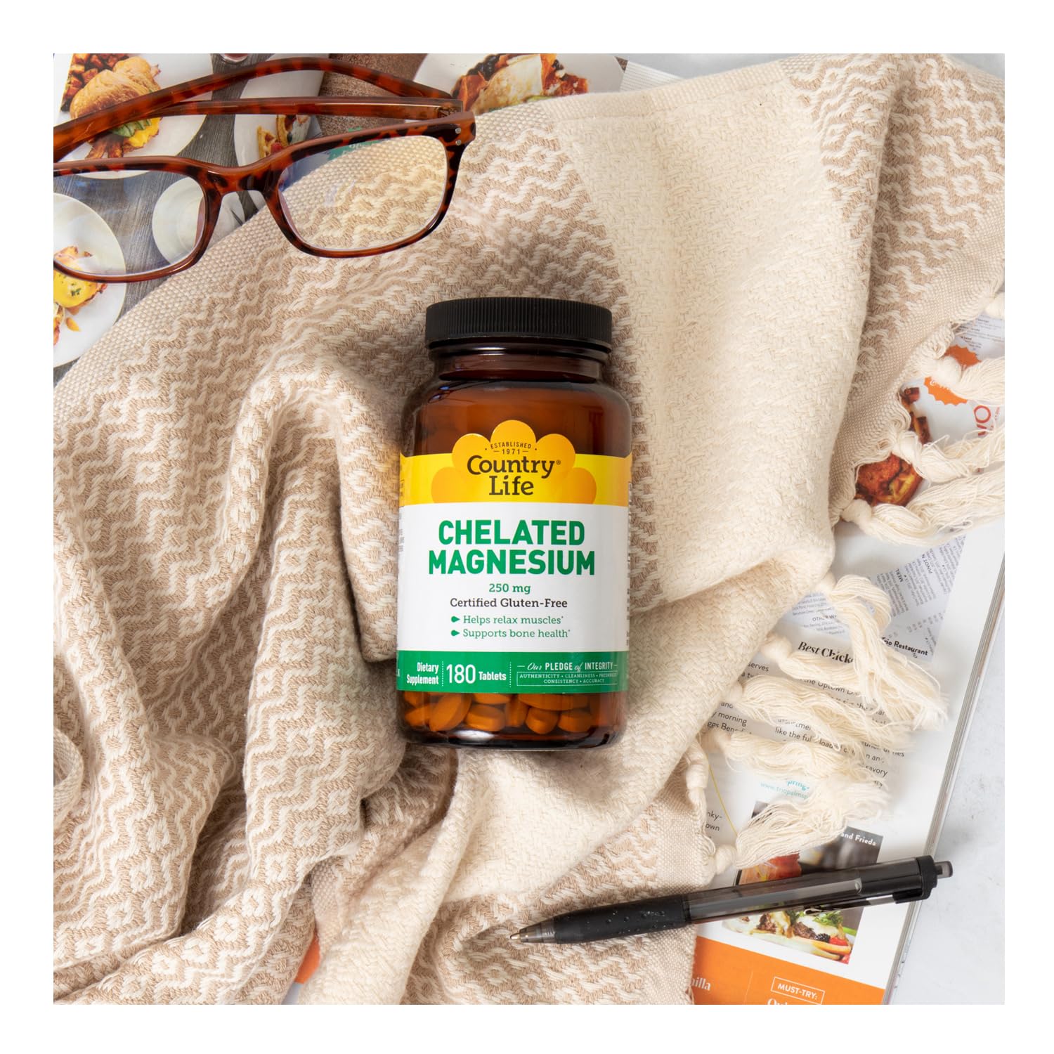 Country Life Chelated Magnesium 250mg bottle on desk demonstrates daily health support