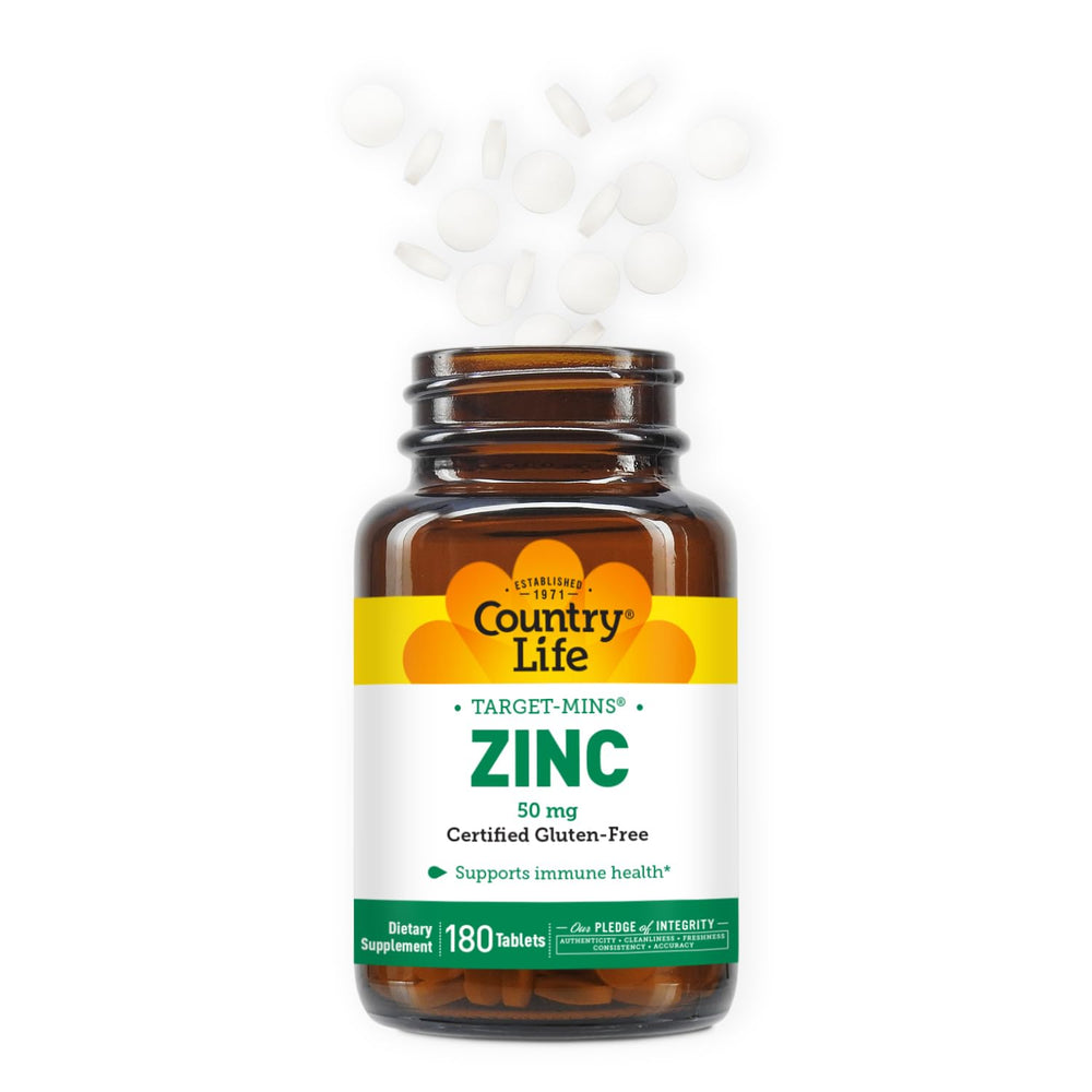 Hands holding a Country Life Target-Mins Zinc tablet for daily use