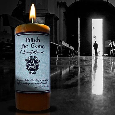 Coventry Creations Bitch Be Gone Mojo candle with herbs and orange hue boosts ritual clarity