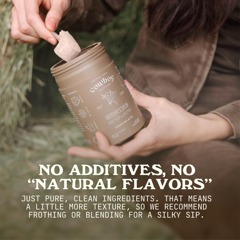 Cowboy Colostrum powder in a glass demonstrates creamy texture for daily use