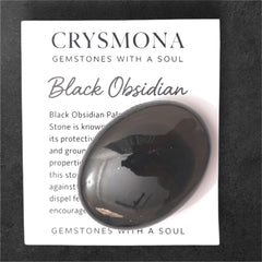 Crysmona polished black obsidian palm stone close-up with glossy finish for calm focus