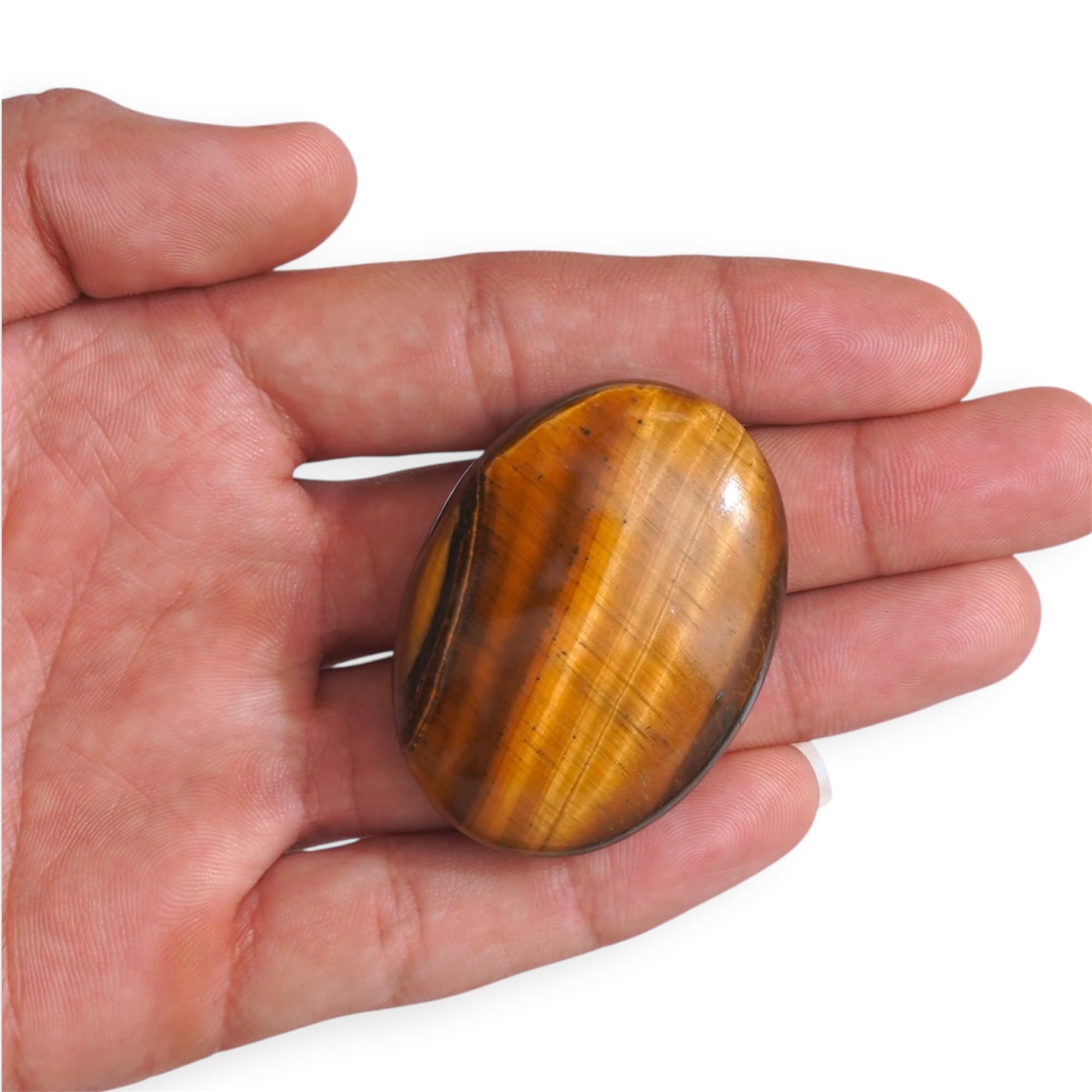Crysmona tiger eye crystal in hand for focus and calm