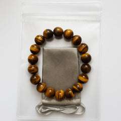 CrystalHouzz Tiger Eye Bracelet on wrist shows comfortable fit for work and travel.