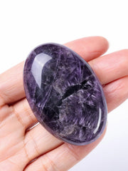 CrystalTears amethyst palm stone in hand helps relieve everyday stress.
