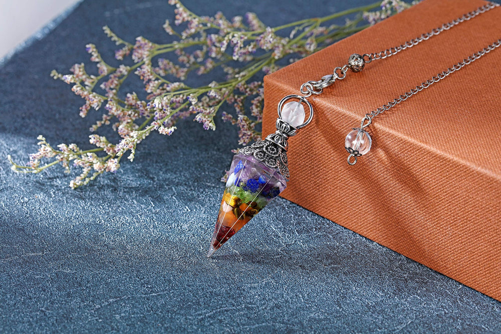 CrystalTears gemstone dowsing pendulum point aiding divination and energy balance during meditation.