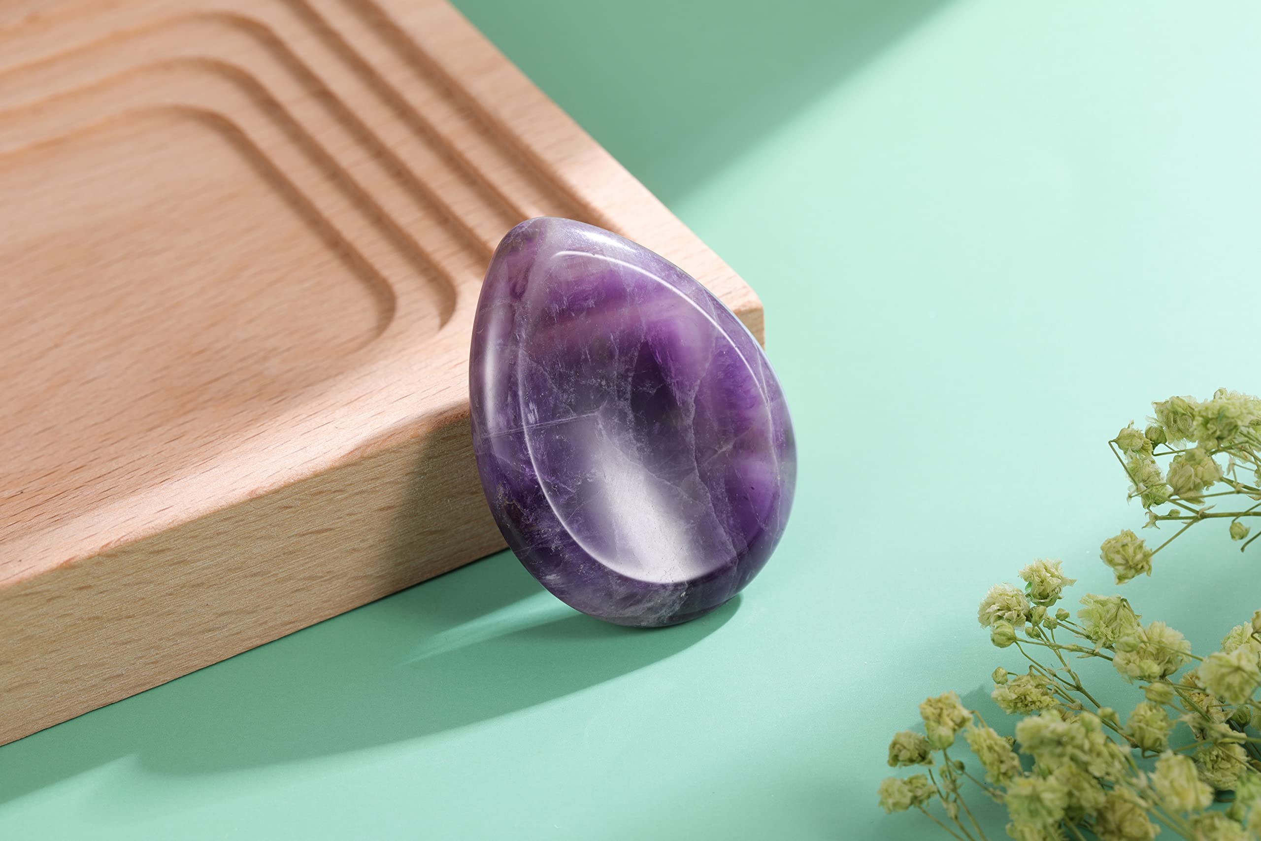 CrystalTears thumb-stone closeup showing the thumb indentation for rubbing