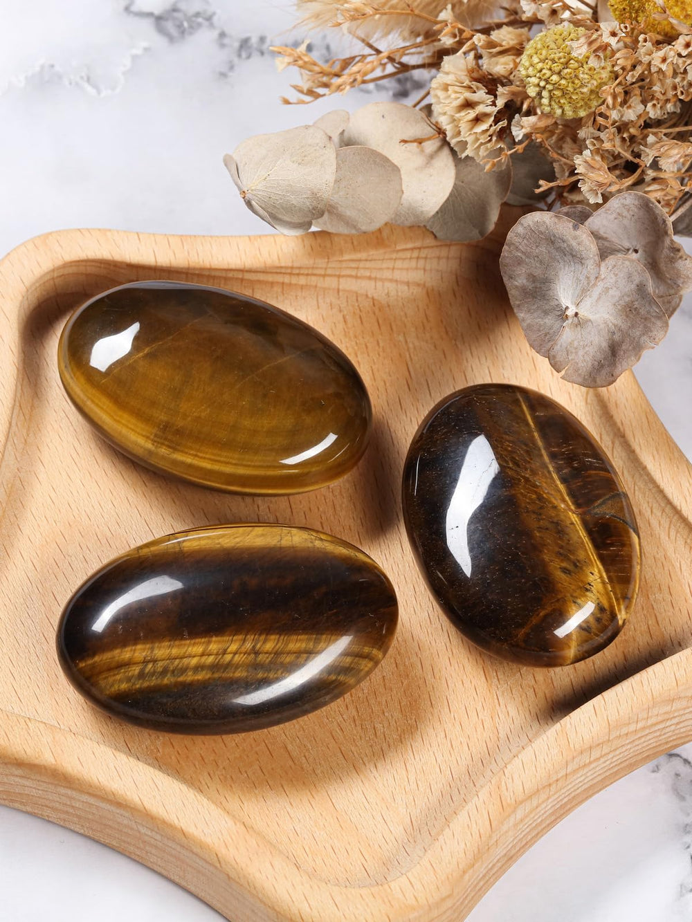 CrystalTears Tiger Eye palm stone with smooth touch for stress relief during meditation.
