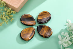 CrystalTears tiger's eye palm stone held for calm focus during busy days