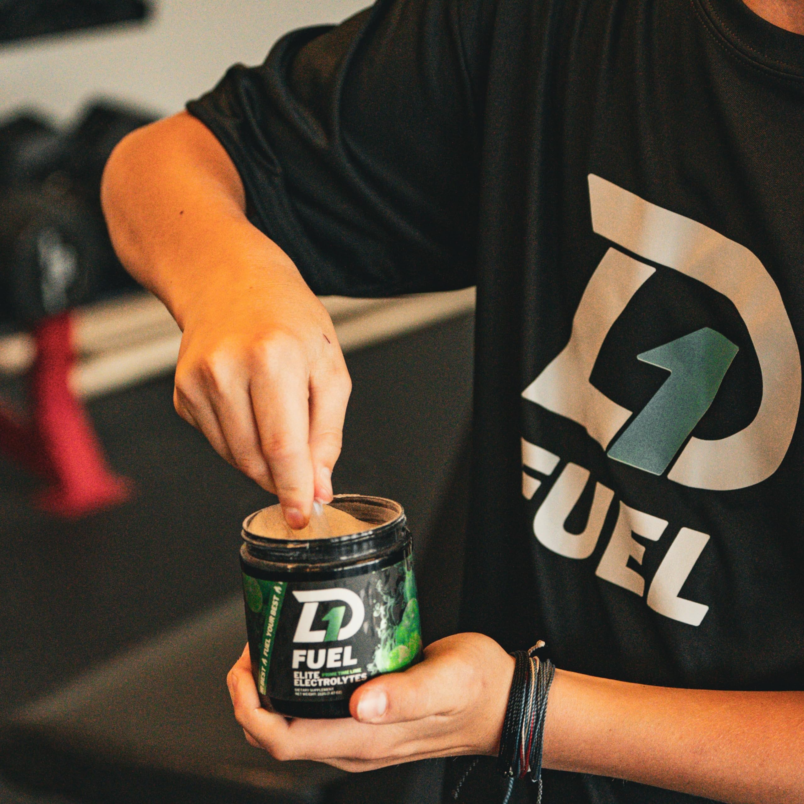 D1 Fuel Prime Time Lime electrolyte scoop demonstrating coconut water boost for rapid hydration.