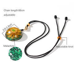 Malachite detail enhances the pendant's natural elegance and strength