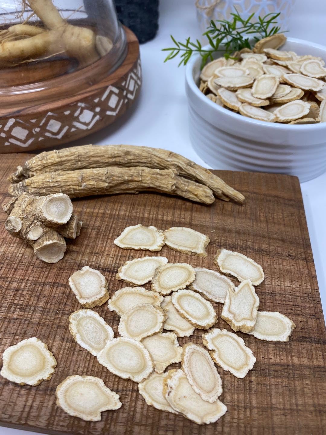 American ginseng slices on a wooden surface for tea or snacking