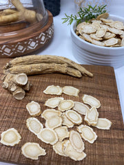 American ginseng slices on a wooden surface for tea or snacking