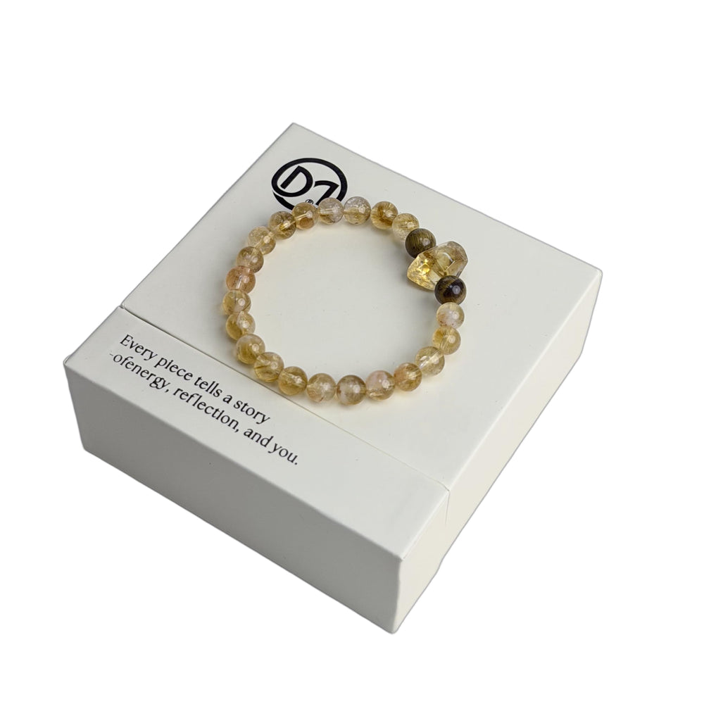 Dare to Mystic bracelet close-up shows golden rutilated quartz beads with tiger's eye for daily focus.