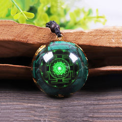 Day Day Up pendant close-up showing malachite patterns and gold foil shimmer.