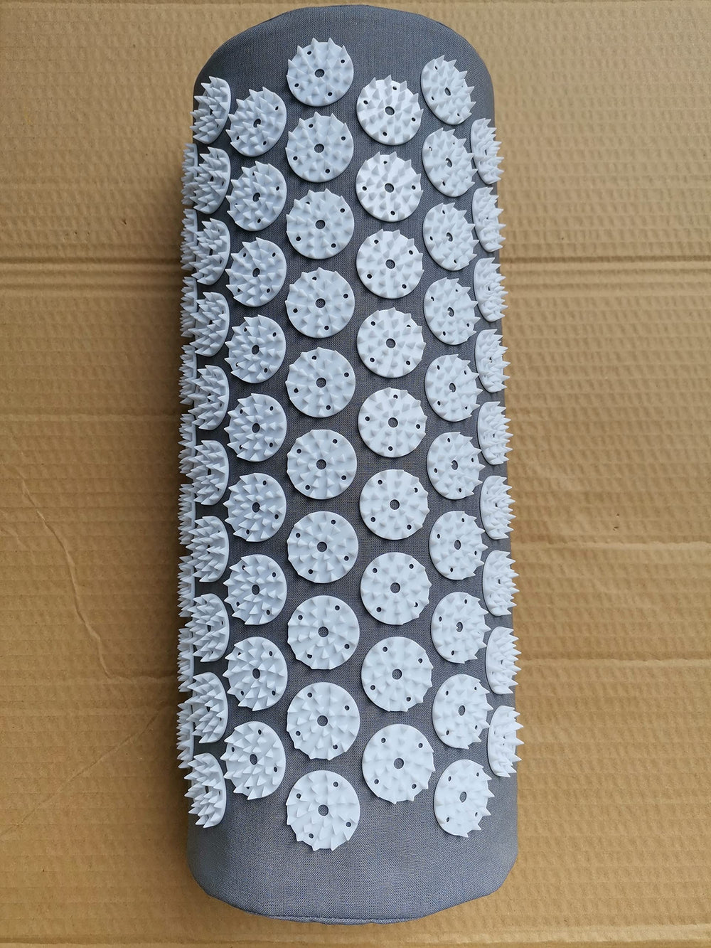 DoroSun acupressure pillow used on neck for tension relief