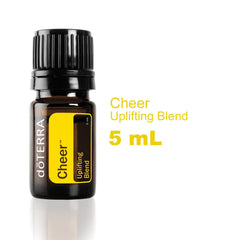doTERRA Cheer bottle pour releasing citrus-spice scent.
