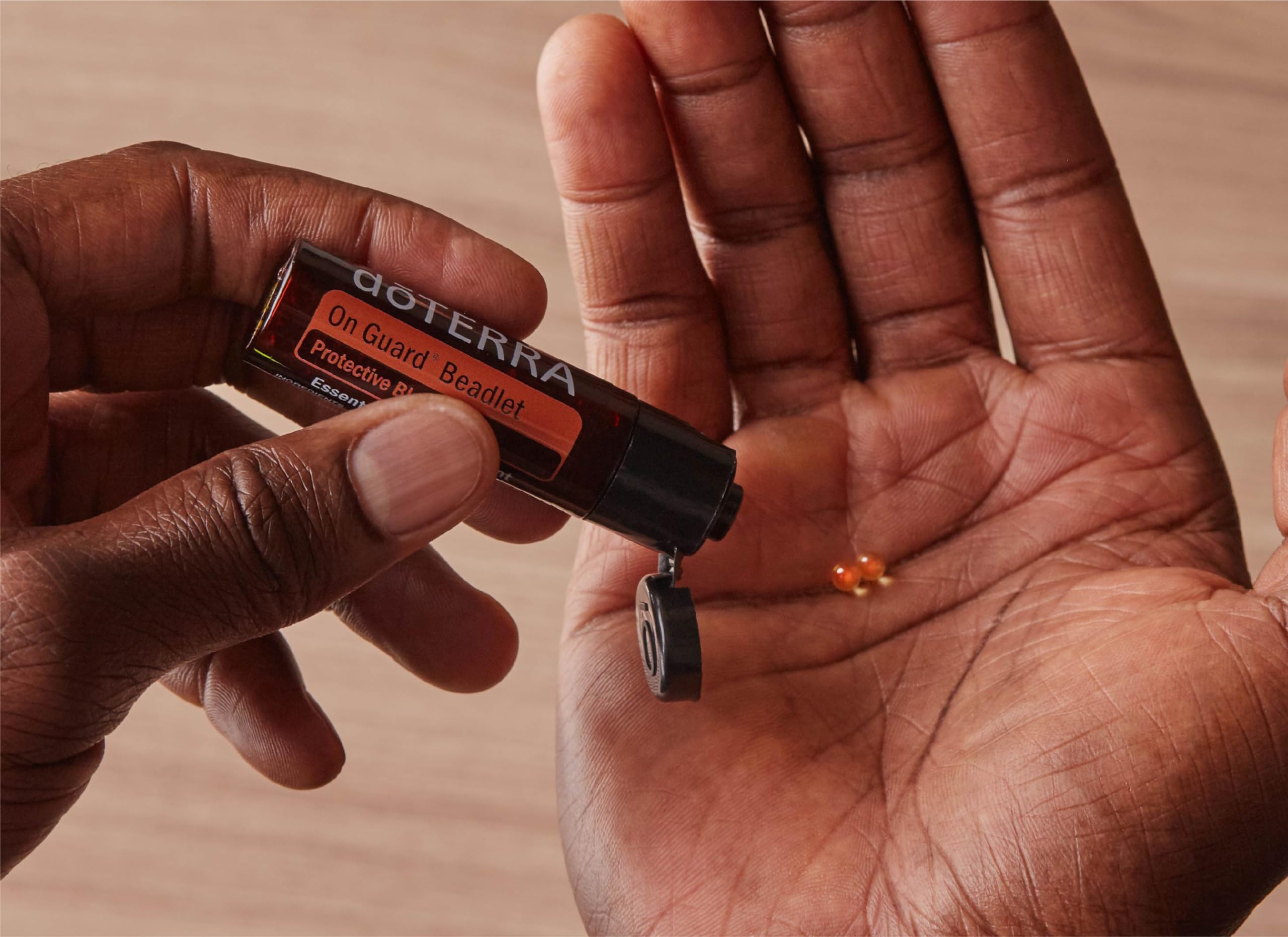 DoTERRA On Guard beadlets close-up melting in the mouth for fresh breath.