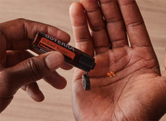 DoTERRA On Guard beadlets close-up melting in the mouth for fresh breath.