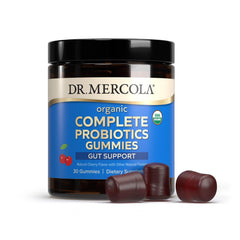 Dr. Mercola Complete Probiotics Gummies cherry-flavored bite ready for daily routine.