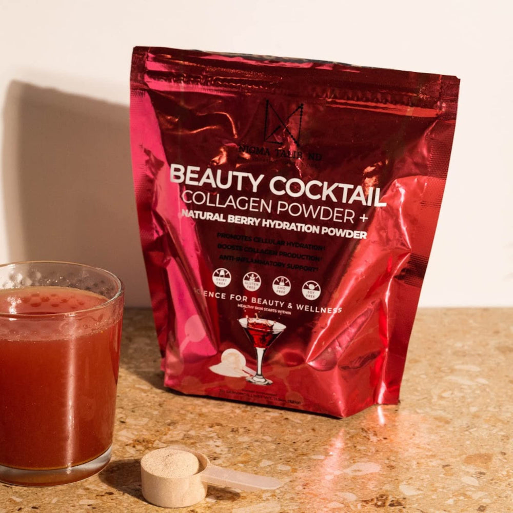 DR. NIGMA Beauty Cocktail powder being stirred into glass of water for refreshing mix