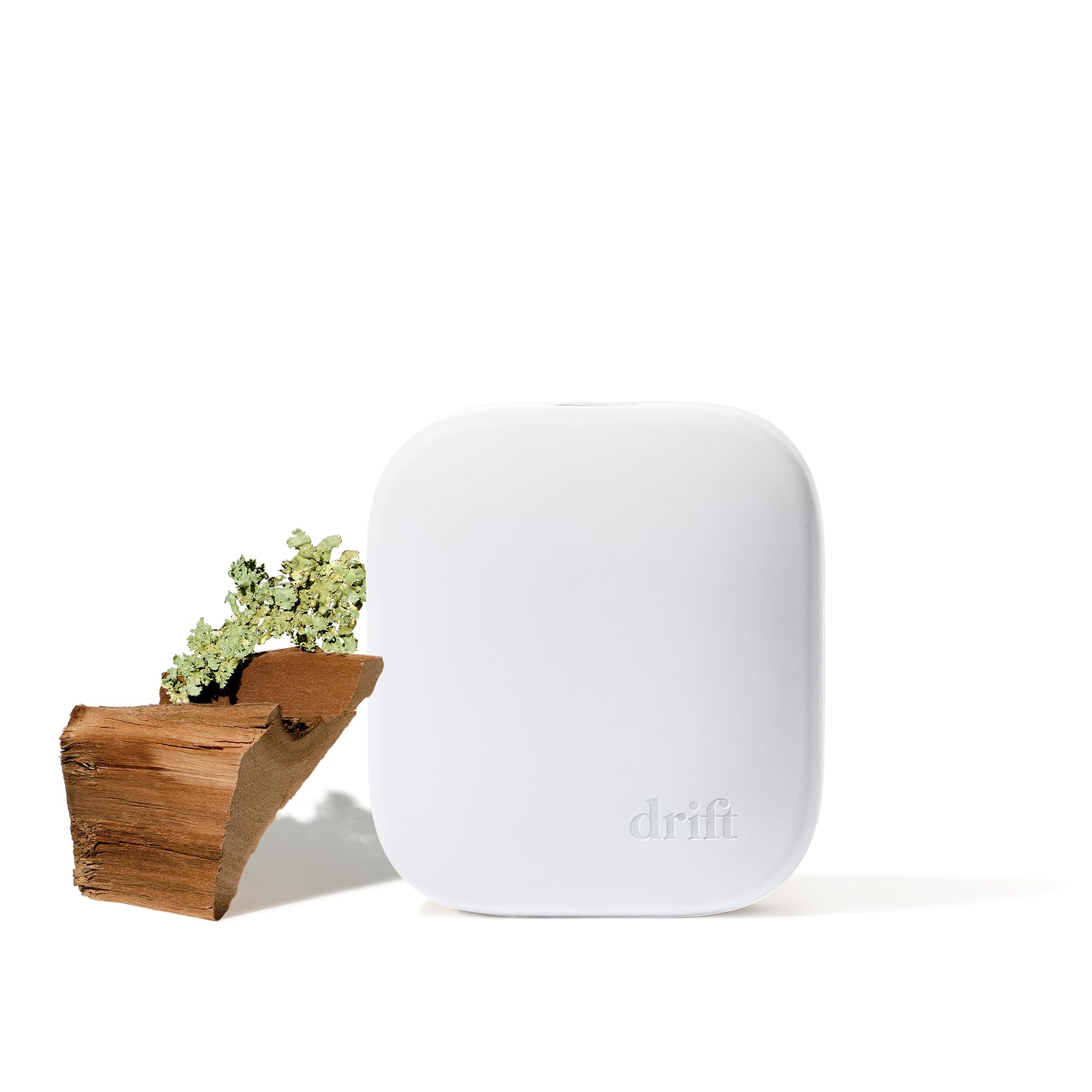 Drift Teak Diffuser Starter Kit box on table radiates inviting aroma for small spaces.