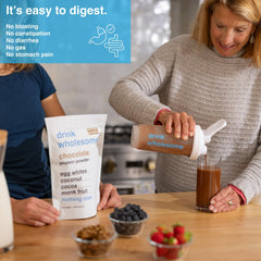Drink Wholesome Chocolate Egg White Protein Scoop shows easy mixing into smoothies for light digestion.