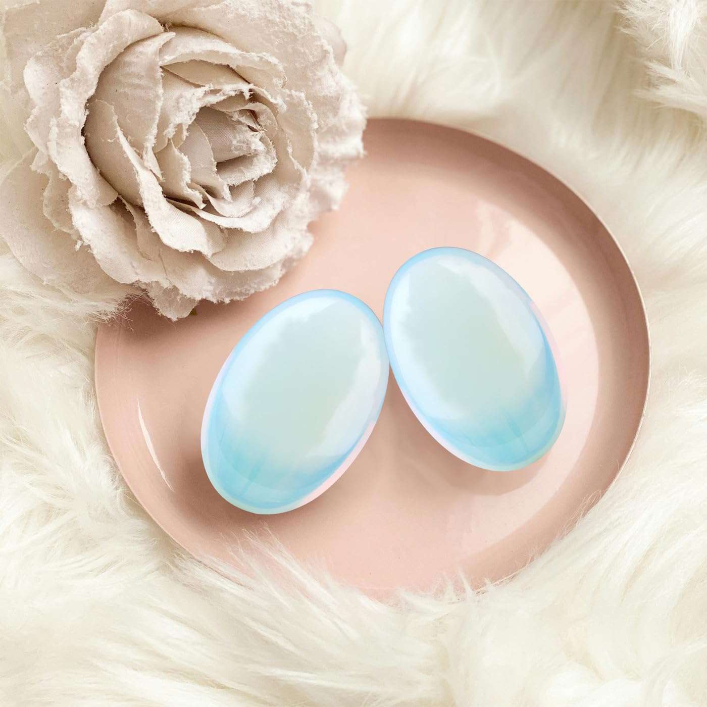 Smooth DUQGUHO opalite palm stone inviting mindful handling.