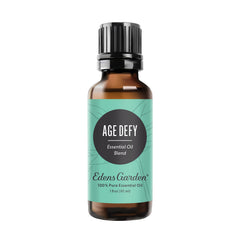 Edens Garden Age Defy essential oil bottle showing woodsy and floral notes for calming rituals.