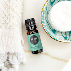 Edens Garden Age Defy bottle close-up highlighting frankincense and sandalwood ingredients.