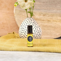 Edens Garden Bliss roll-on application demonstrates convenient on-the-go relaxation.
