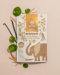 Elements Truffles vanilla protein shake in glass for convenient on-the-go meals.