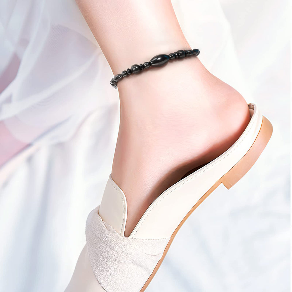 Close-up of Emibele magnetic therapy anklet highlighting smooth beads and flexible fit.