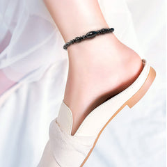 Close-up of Emibele magnetic therapy anklet highlighting smooth beads and flexible fit.