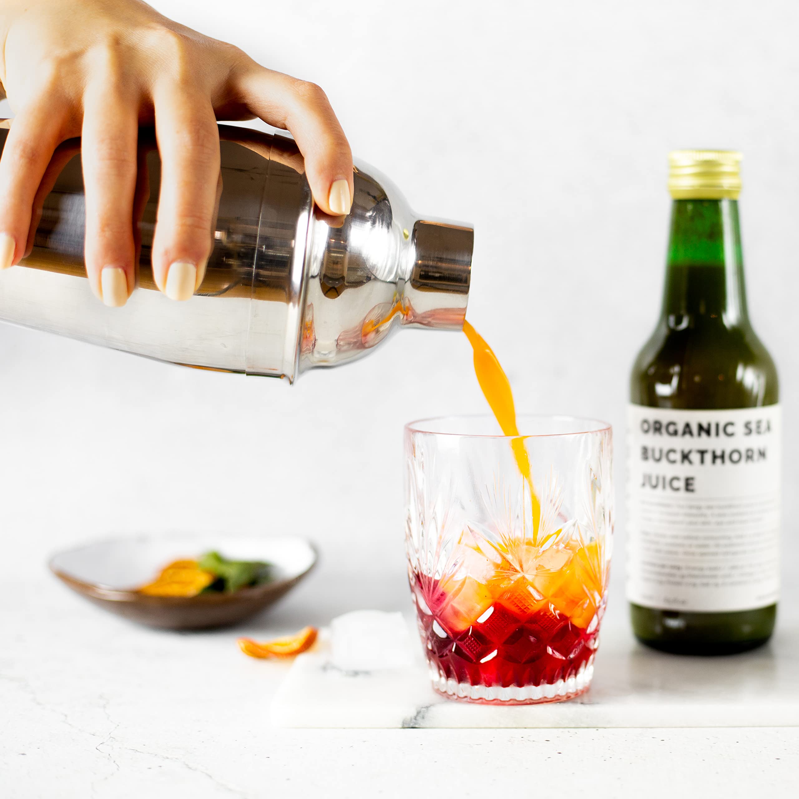 Erbology sea buckthorn juice being poured, showcasing tart citrus notes for a refreshing boost.