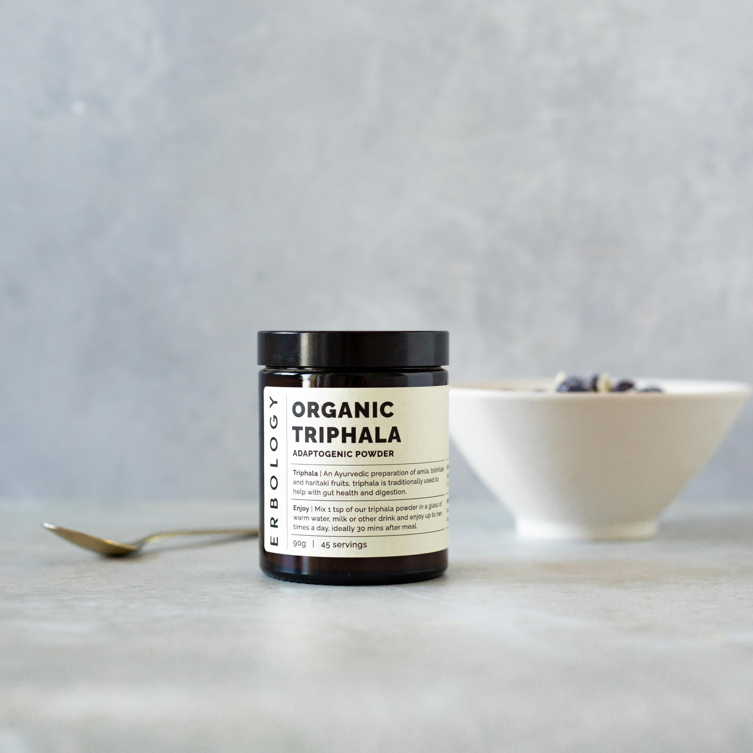 Erbology Triphala powder blend of amla, haritaki, and bibhitaki for daily smoothies.