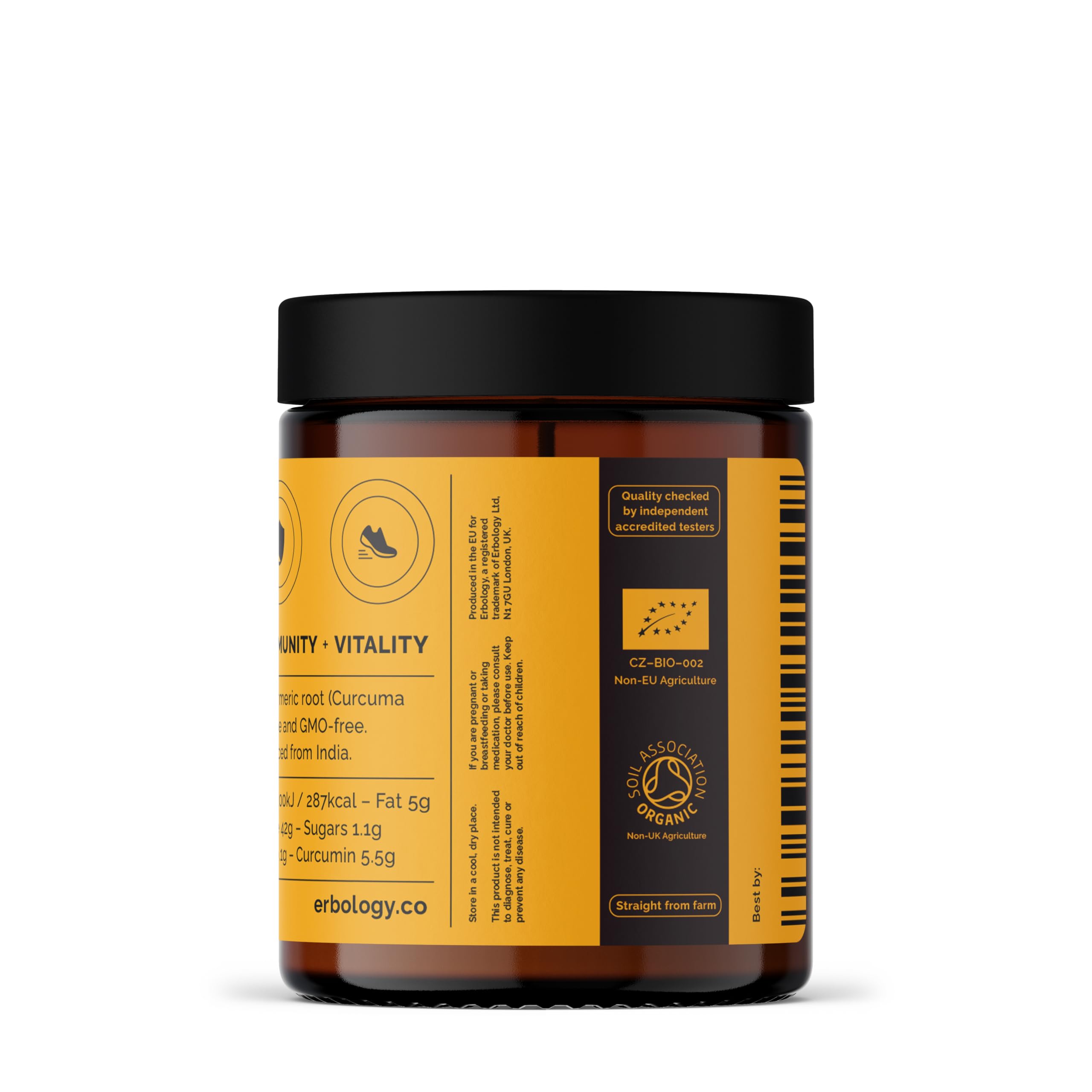 Glass jar of Erbology turmeric powder on kitchen counter.