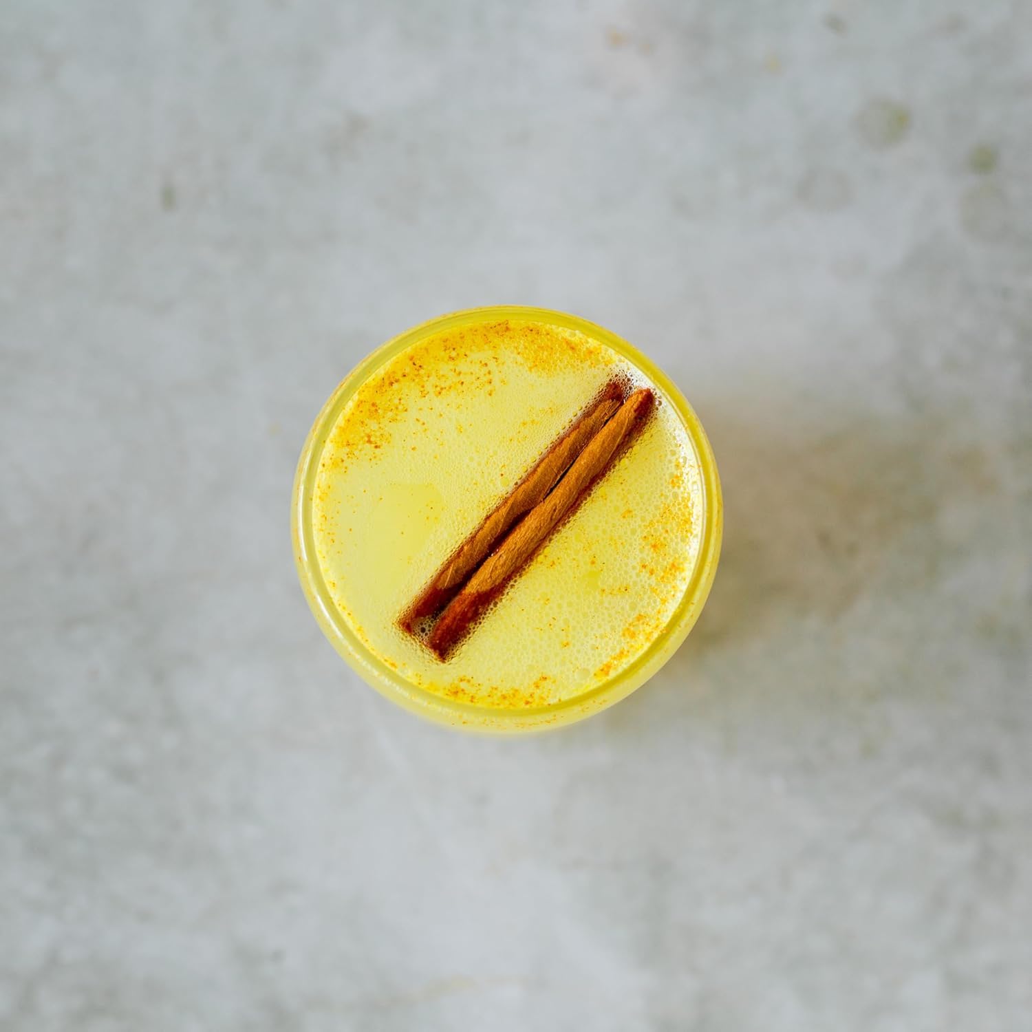Erbology golden milk preparation with turmeric powder and pepper.