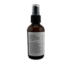Spray bottle in action for quick, non-greasy application on shoulders.