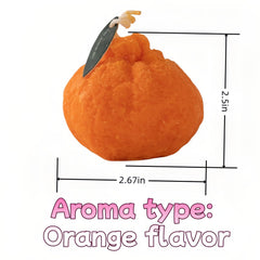 FANBODTA orange candle on desk with warm glow enhances small-space relaxation.