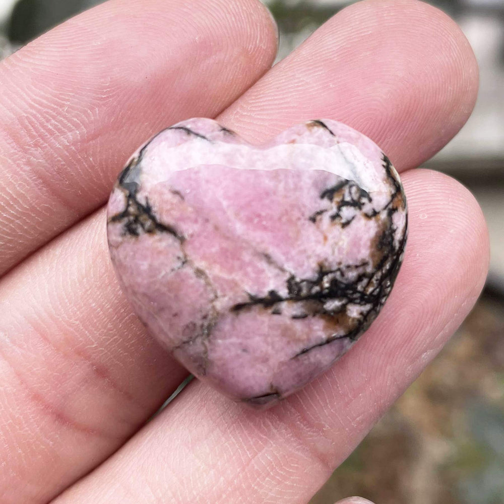 Fekuar rhodonite heart close-up with polished surface for relaxation and focus.