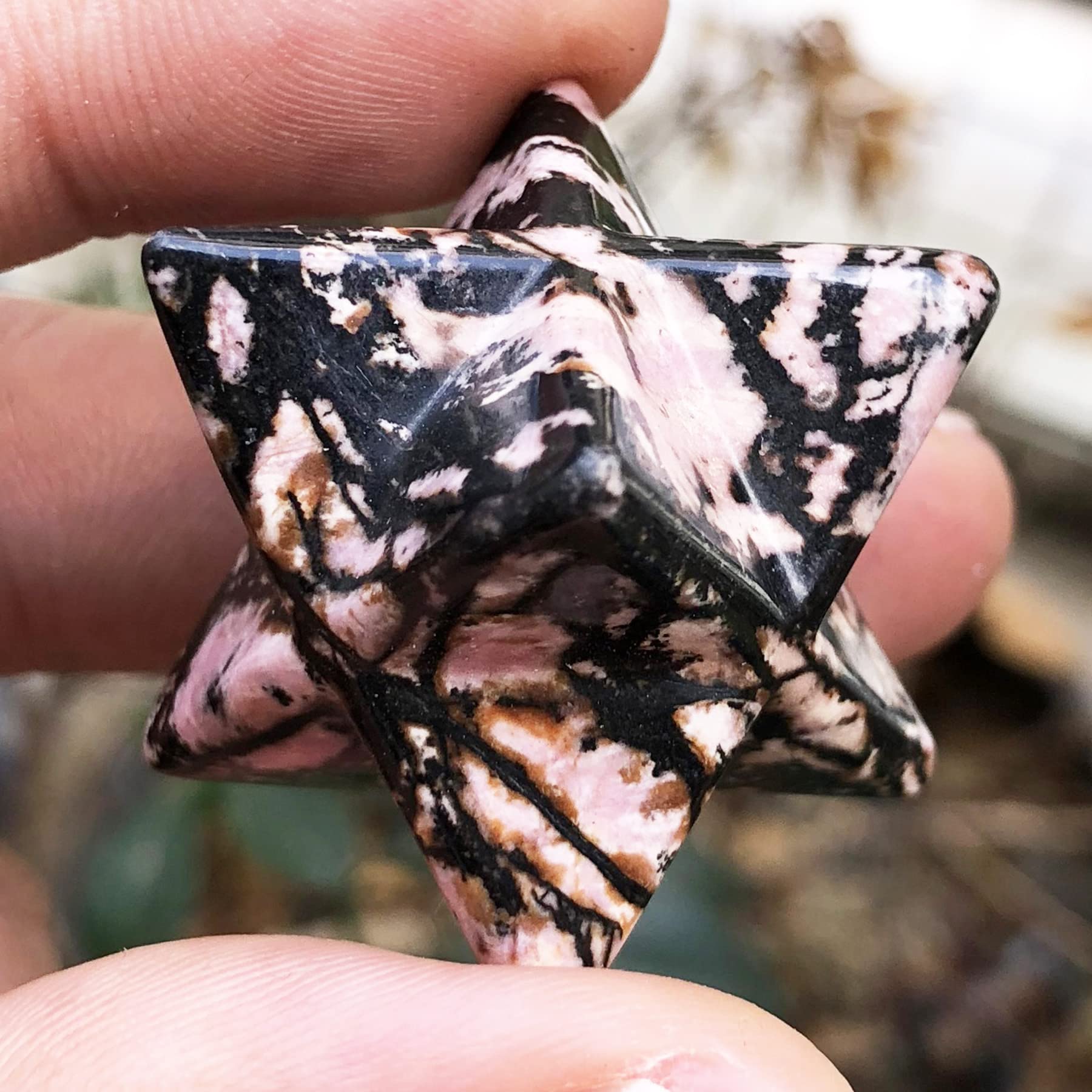 Fekuar Rhodonite Merkaba Star on crystal grid to amplify focused energy and intention.