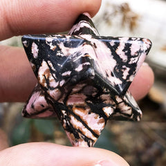 Fekuar Rhodonite Merkaba Star on crystal grid to amplify focused energy and intention.