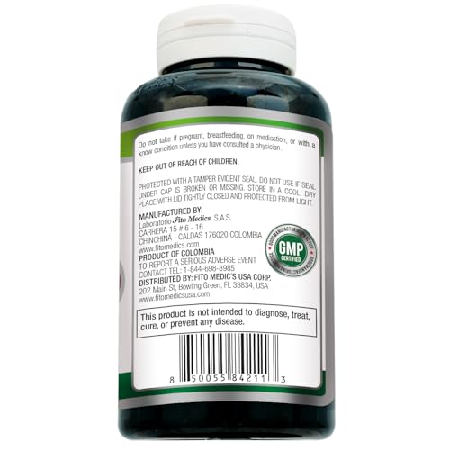 Close-up of Fitomedics bottle with capsules ready for daily intake.