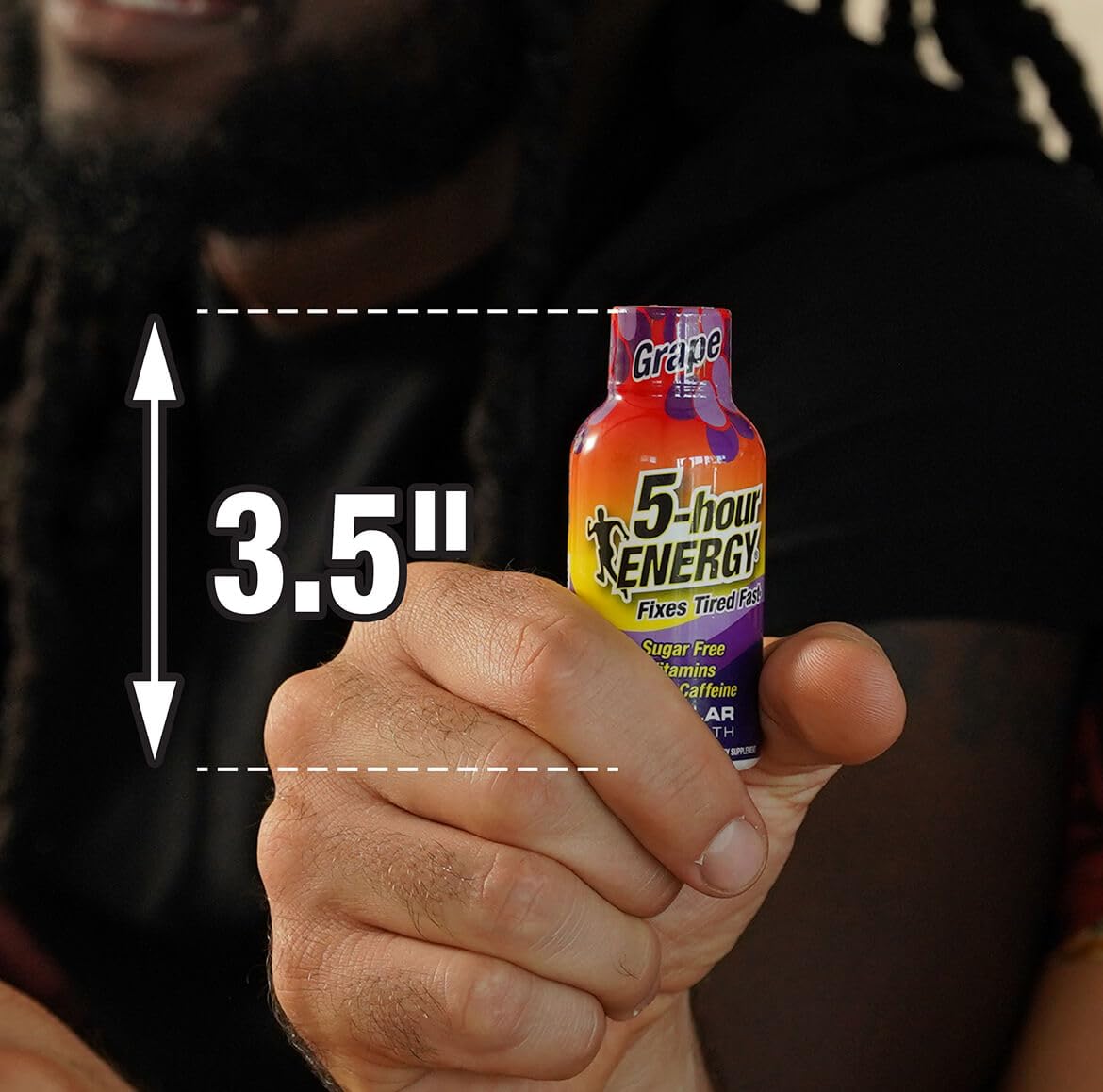 5-hour ENERGY grape regular energizing shot in hand for quick focus.