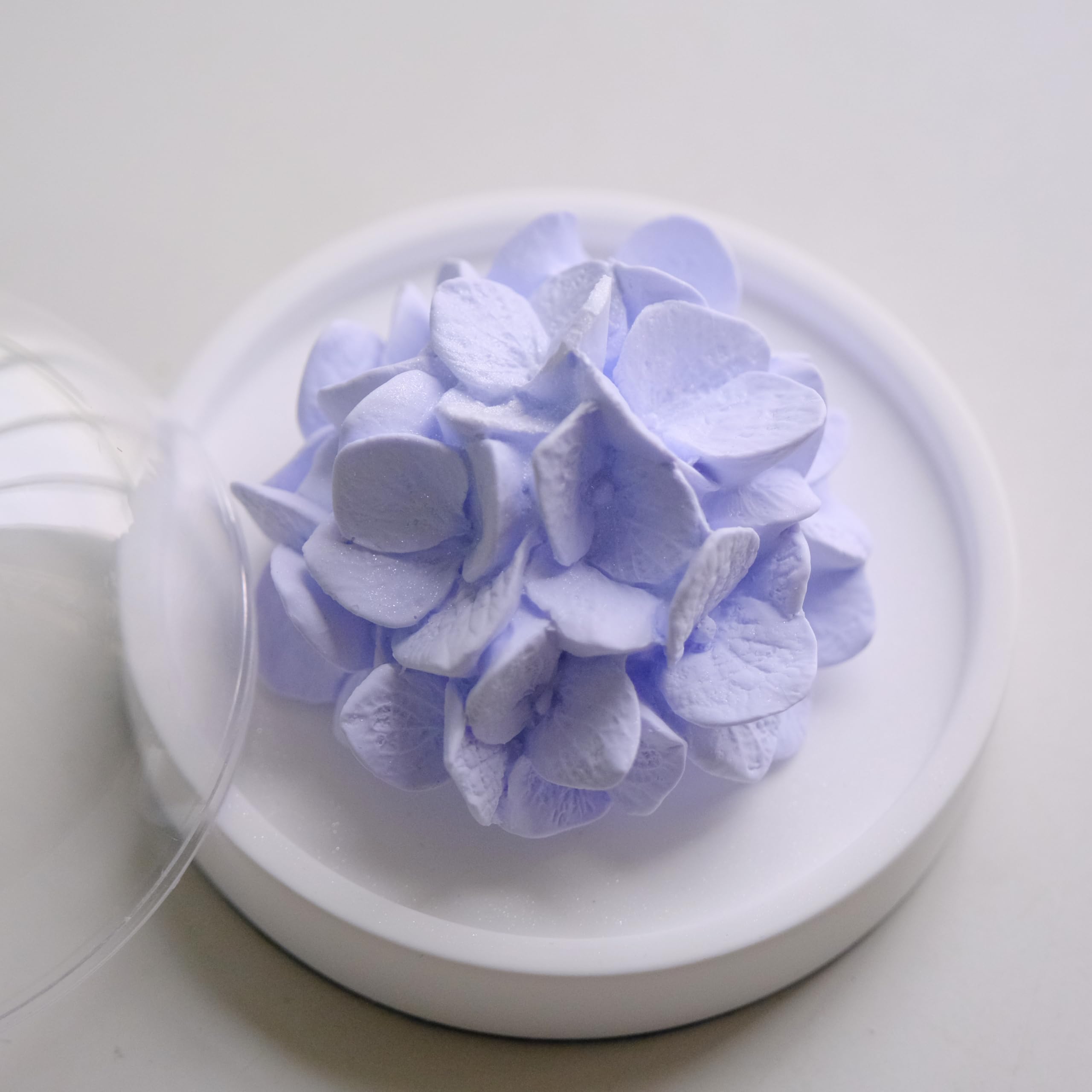 FLCSIed porcelain flower diffuser on natural wood base, perfect as desk decor.