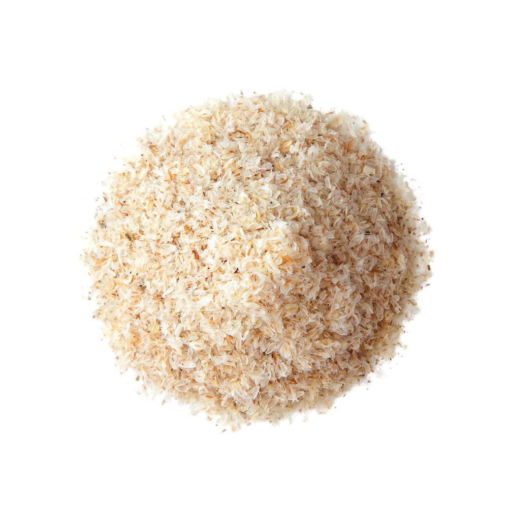 Food to Live psyllium husks poured into water, creating a thickening layer.