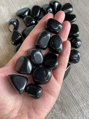 GAF Treasures Black Obsidian tumbled stone close-up for meditation and focus.