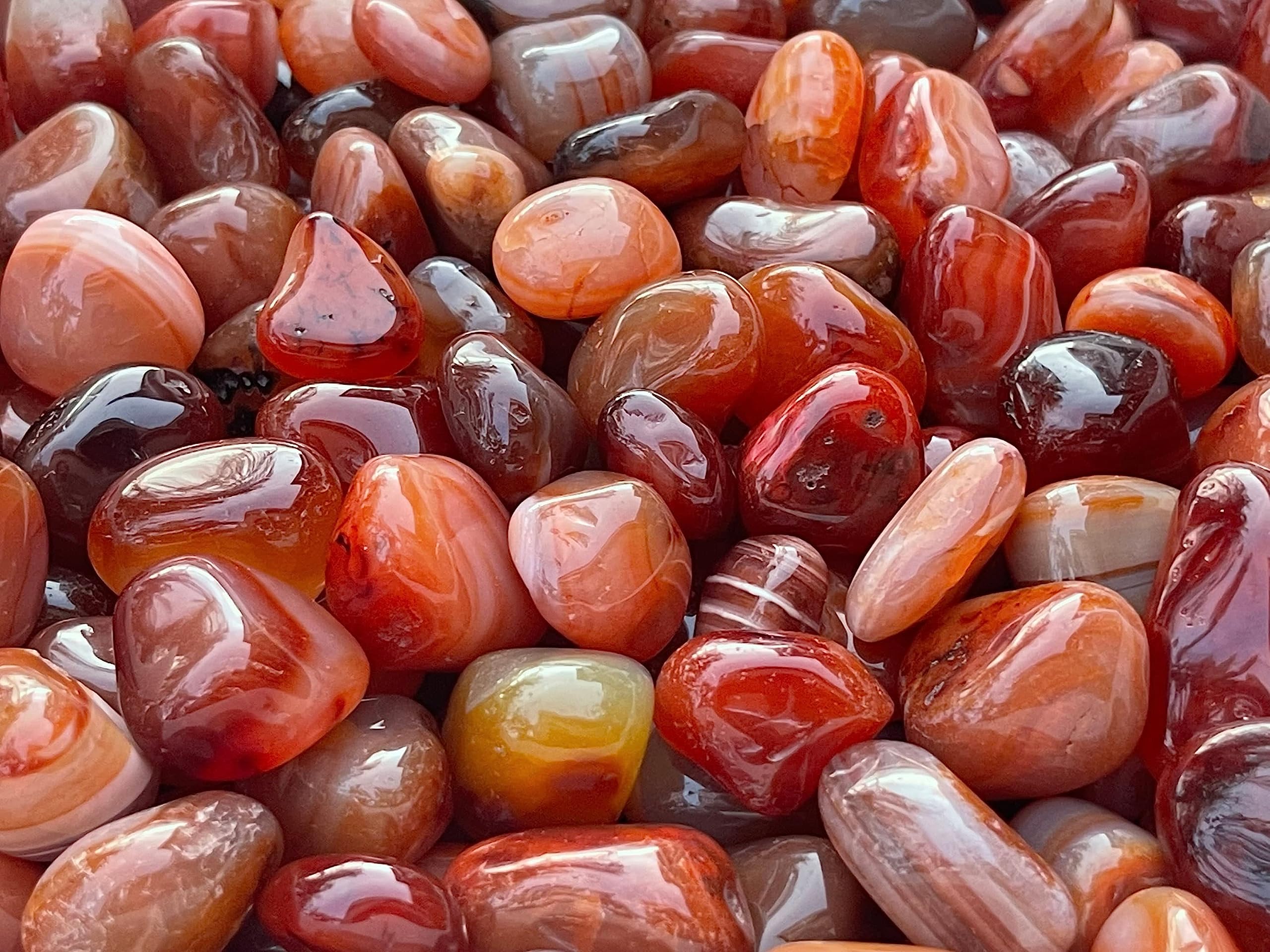 GAF TREASURES Carnelian stones beside a journal for daily reminders and creative flow