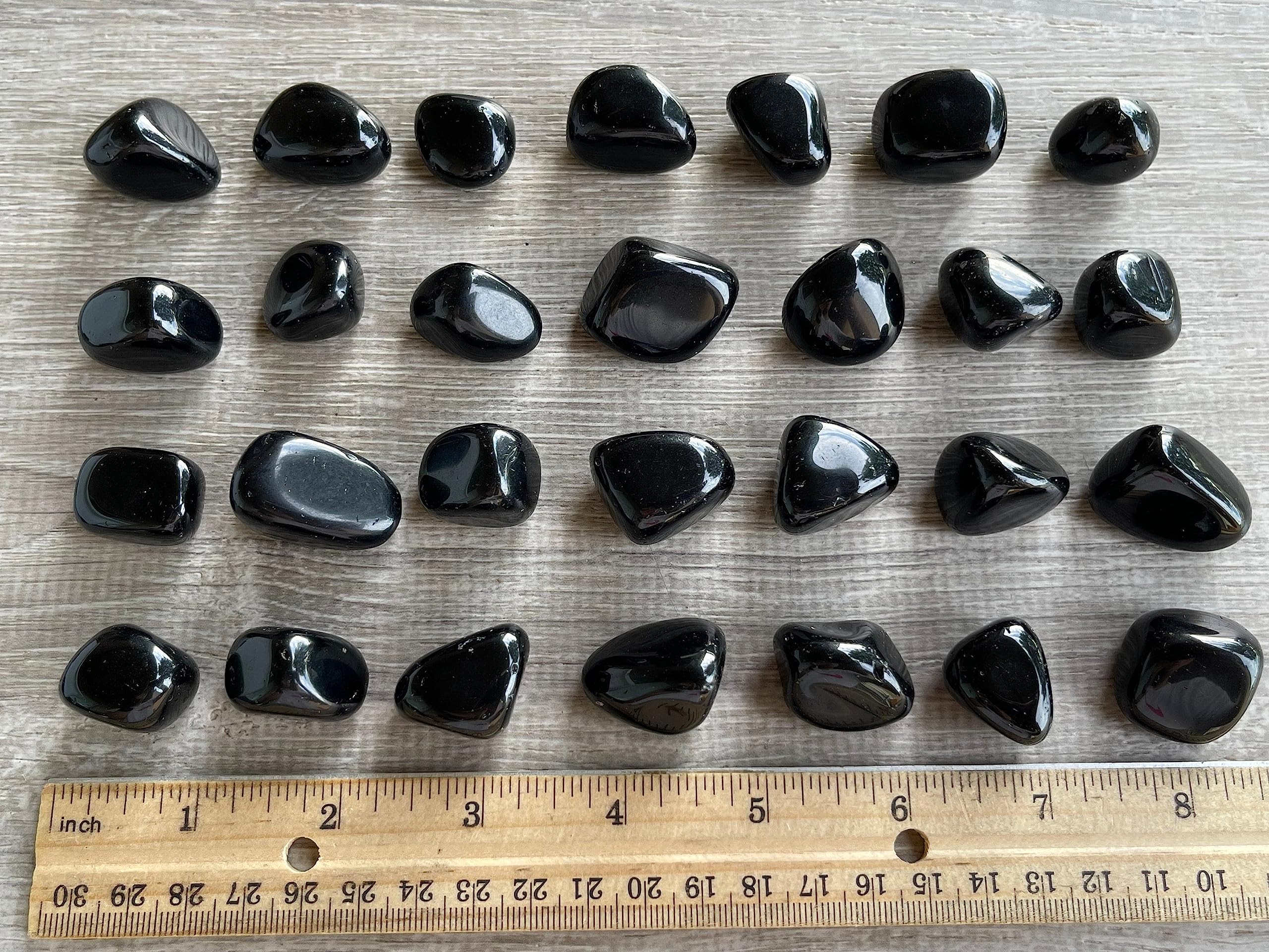 Person holds GAF TREASURES Black Obsidian stones during meditation.